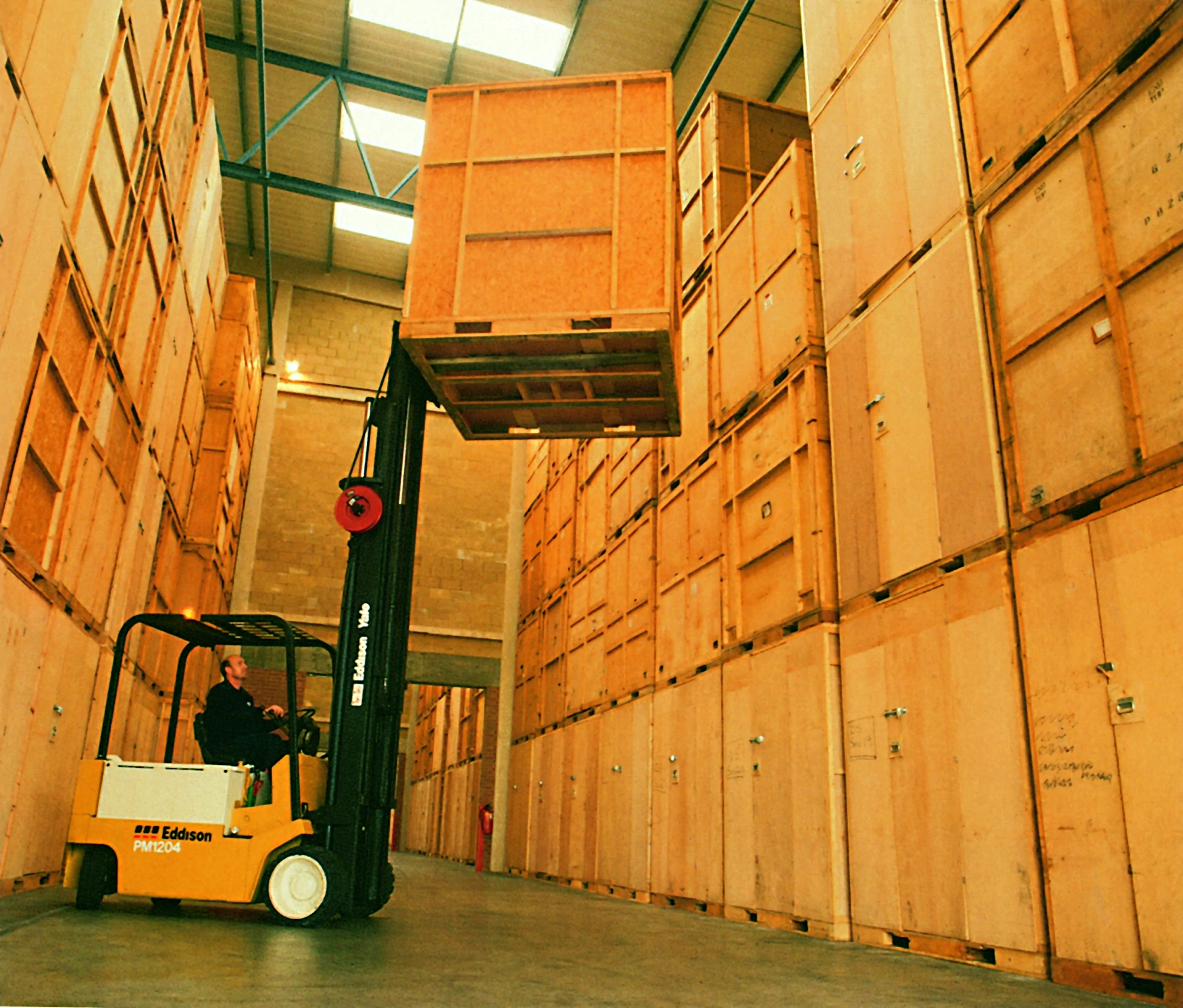 Forklift loading a palleted crate